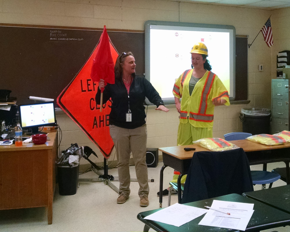 photo of Rose Harrell, City of Virginia Beach, demonstrating how to properly control and slow traffic down to a New Horizons cadet